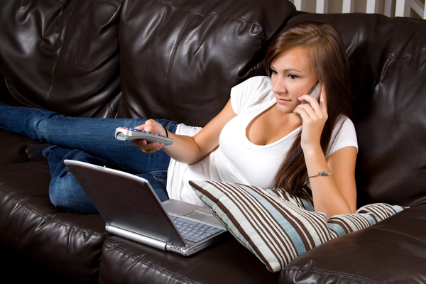 Landline telephones - girl using mobile watching TV