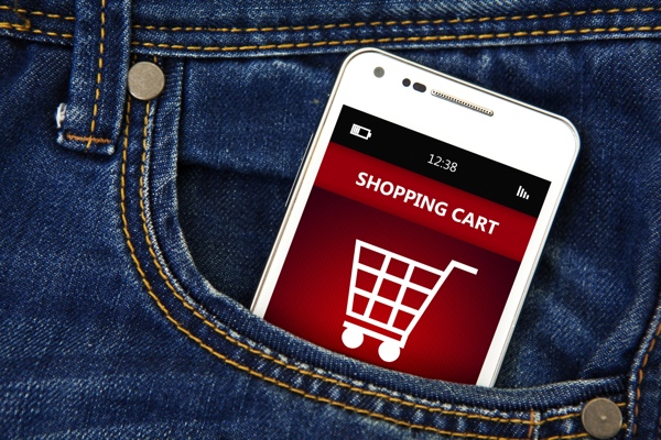mobile phone with shopping cart in jeans pocket